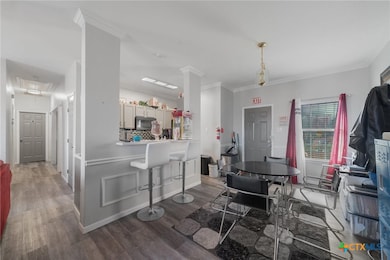 Dining room with dark hardwood / wood-style floors