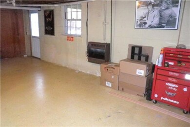 Extra living/storage space in this full basement with gas wall heater and Schrader wood stove.