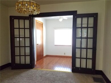 French doors to den with roomy closet.
