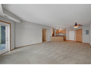 living room facing kitchen, door to bedroom