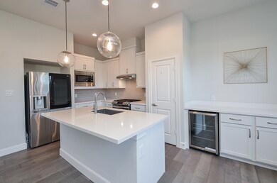 A generous island with bar seating provides extra prep space and a perfect spot for casual dining or morning coffee.