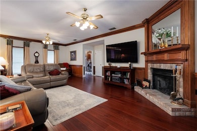 Living area featuring visible vents, dark wood-sty