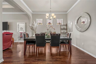 Dining space with a chandelier, dark wood-style fl