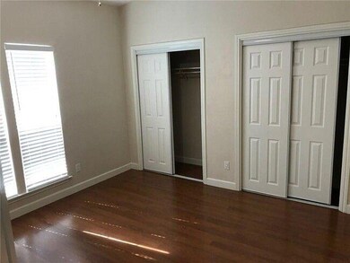 Unfurnished bedroom with baseboards, two closets,