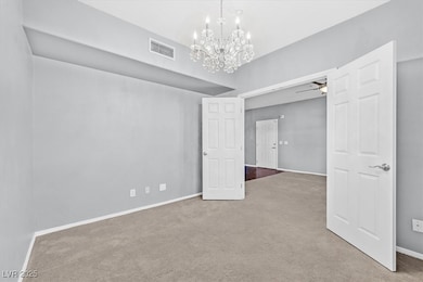 Carpeted spare room featuring ceiling fan with not