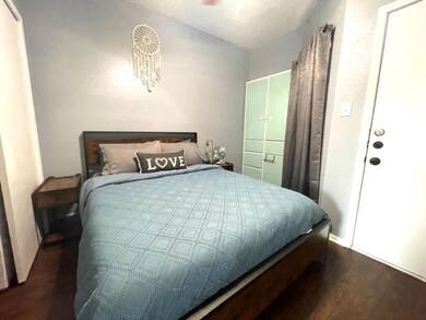 Bedroom with dark wood finished floors