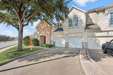 View of front of house with driveway, stone siding