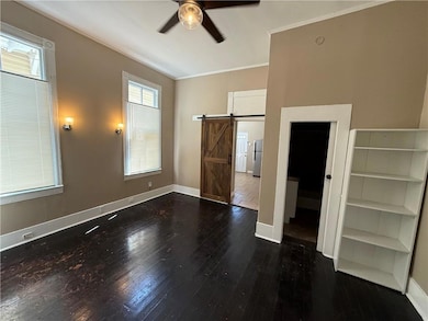 Unfurnished bedroom with crown molding, freestandi