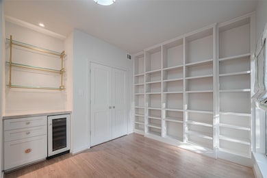 Large Closet with Wet Bar and wall of shelves.
