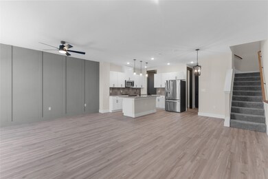 Unfurnished living room with stairs, light wood finished floors, a chandelier, ceiling fan, and recessed lighting