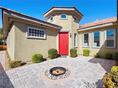View of front facade with stucco siding, a fire pi
