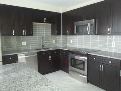 Kitchen with island, under-lit cabinets and SS app