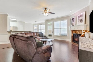 Living room featuring crown molding, a ceiling fan
