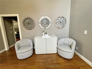 Sitting room with wood finished floors and baseboards