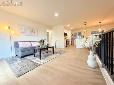 Living room with light wood-style flooring, recessed lighting, and baseboards