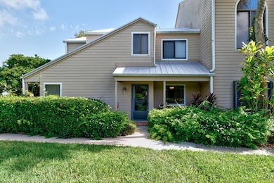 View of front of house featuring a metal roof, covered porch, and a front yard