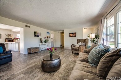 ANOTHER VIEW OF THE SPACIOUS LIVING ROOM