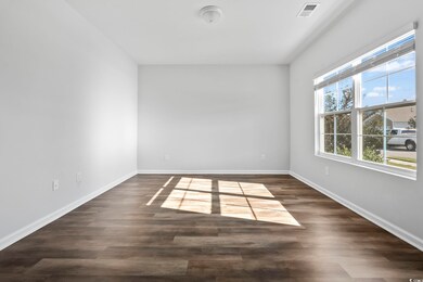 Unfurnished room with dark wood-style floors and baseboards
