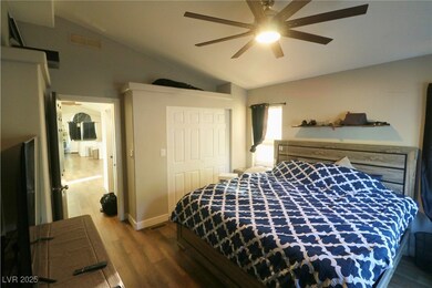 Bedroom featuring lofted ceiling, dark wood-type flooring, a closet, and ceiling fan