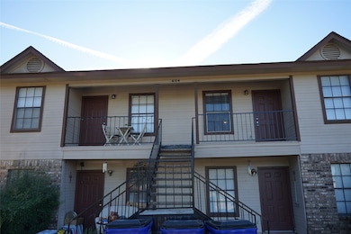 View of front of home featuring brick siding and stairs
