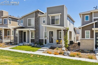View of front of house with stone siding and a covered patio