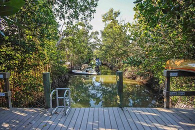 Deck with a boat dock and a water view