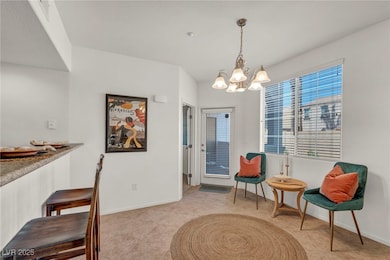 dining room with a chandelier, baseboards, and lig