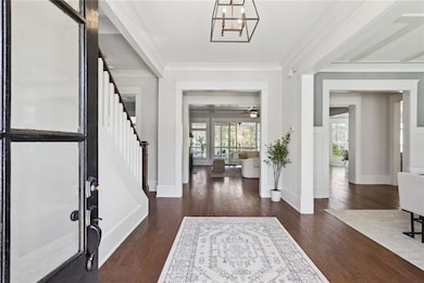 Entrance foyer with stairs, crown molding, baseboa