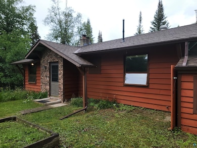 Back of property featuring a lawn