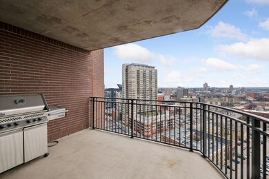 First deck off the main living space with attached gas grill.