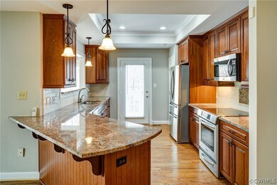 Kitchen has granite countertops under cabinet ligh