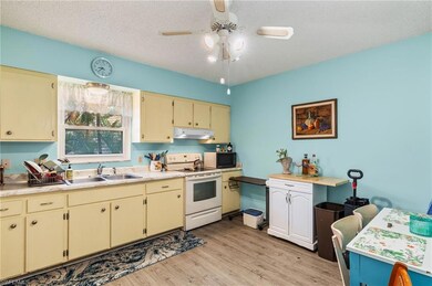 Kitchen with a textured ceiling, white electric st