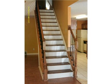 Pretty wrought iron staircase off of living room g