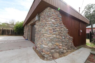 Side of home with rock and metal siding