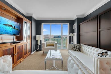 Living area featuring baseboards and ornamental mo