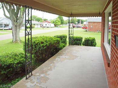 Iron lace supports this wide front porch that is d