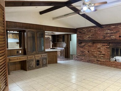 Unfurnished living room featuring beamed ceiling, 
