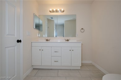 Bathroom featuring vanity and tile patterned floor