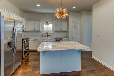 Kitchen with a center island, stainless steel appl