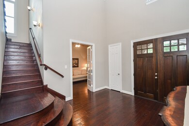 Enter into the foyer with beautiful wood floors, s