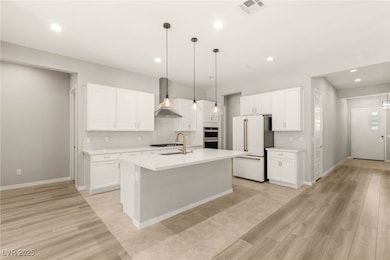Kitchen with freestanding refrigerator, light coun