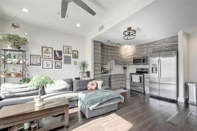 Living area with recessed lighting, dark wood-sty