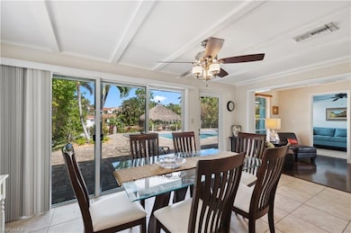 Dining space with beamed ceiling, ceiling fan, and