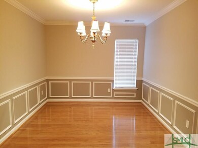 Deeper shade of grey accents the chair rail and wa