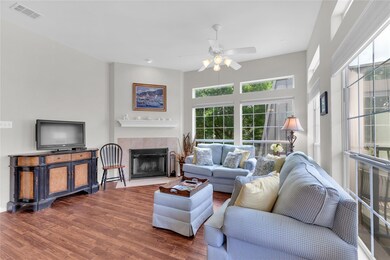 Living area with a ceiling fan, wood finished flo