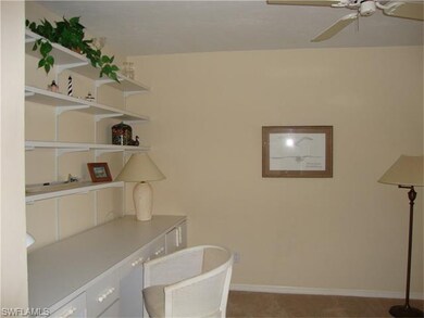 Den off the foyer.  the desk and shelves are easil