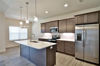 Kitchen with light hardwood / wood-style flooring,