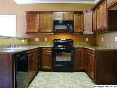 Kitchen with warm cabinet color tones