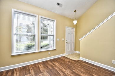 Entrance foyer with a textured ceiling and hardwoo