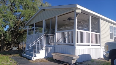 View of side of home featuring a sunroom and stair